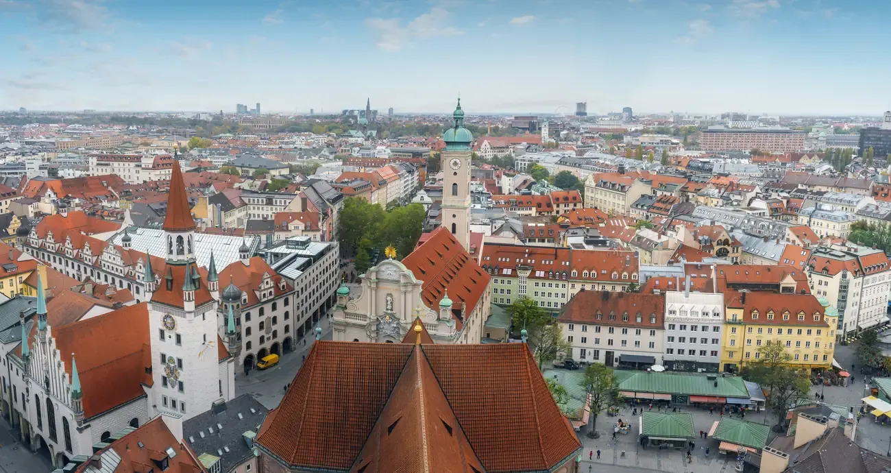 Aerial view of the Viktualienmarkt stalls beside the Heiliggeistkirche and the Old Town Hall tower in Munich