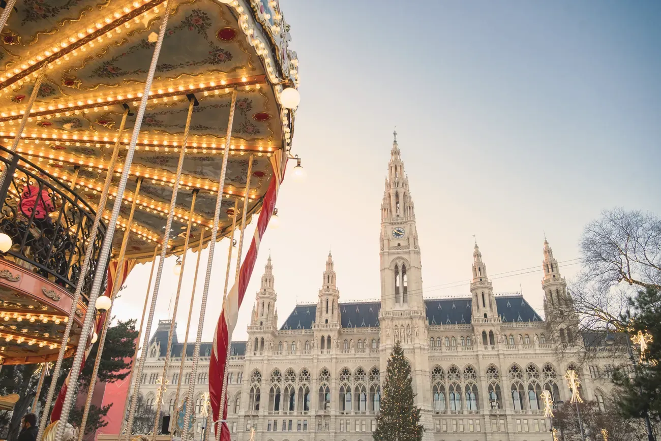 Illuminated vintage carousel at the Christmas market in front of Vienna City Hall on Rathausplatz