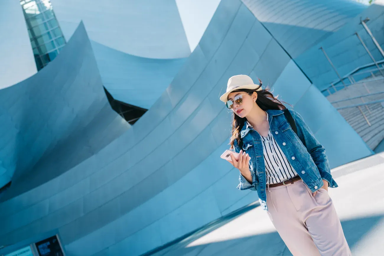 A visitor on the stairway beside the steel facade of the Walt Disney Concert Hall in Los Angeles