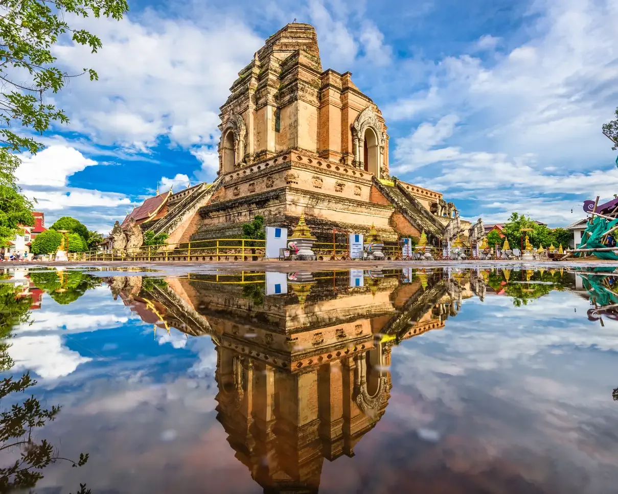 The ancient Wat Chedi Luang temple reflected in water, Chiang Mai