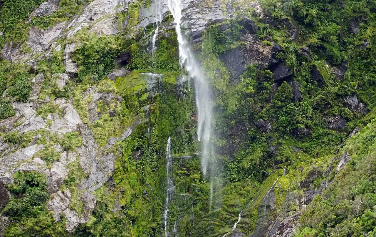 A waterfall dropping down the cliff face into Milford Sound