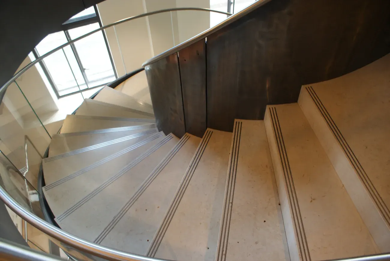 The curving stone spiral staircase inside Wellcome Collection on Euston Road, London