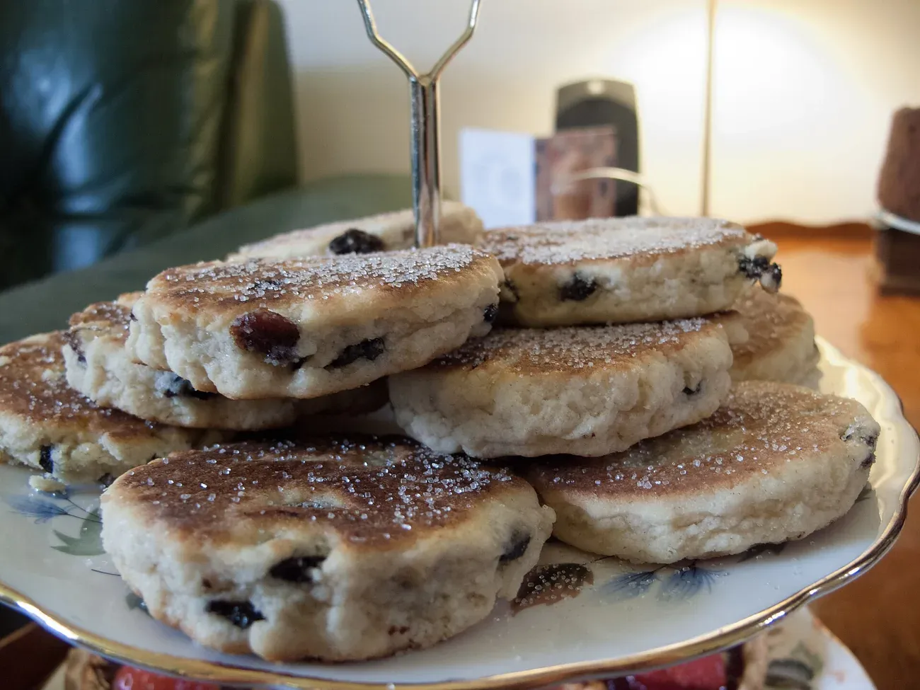 Welsh cakes dusted with sugar and stacked on a cake stand