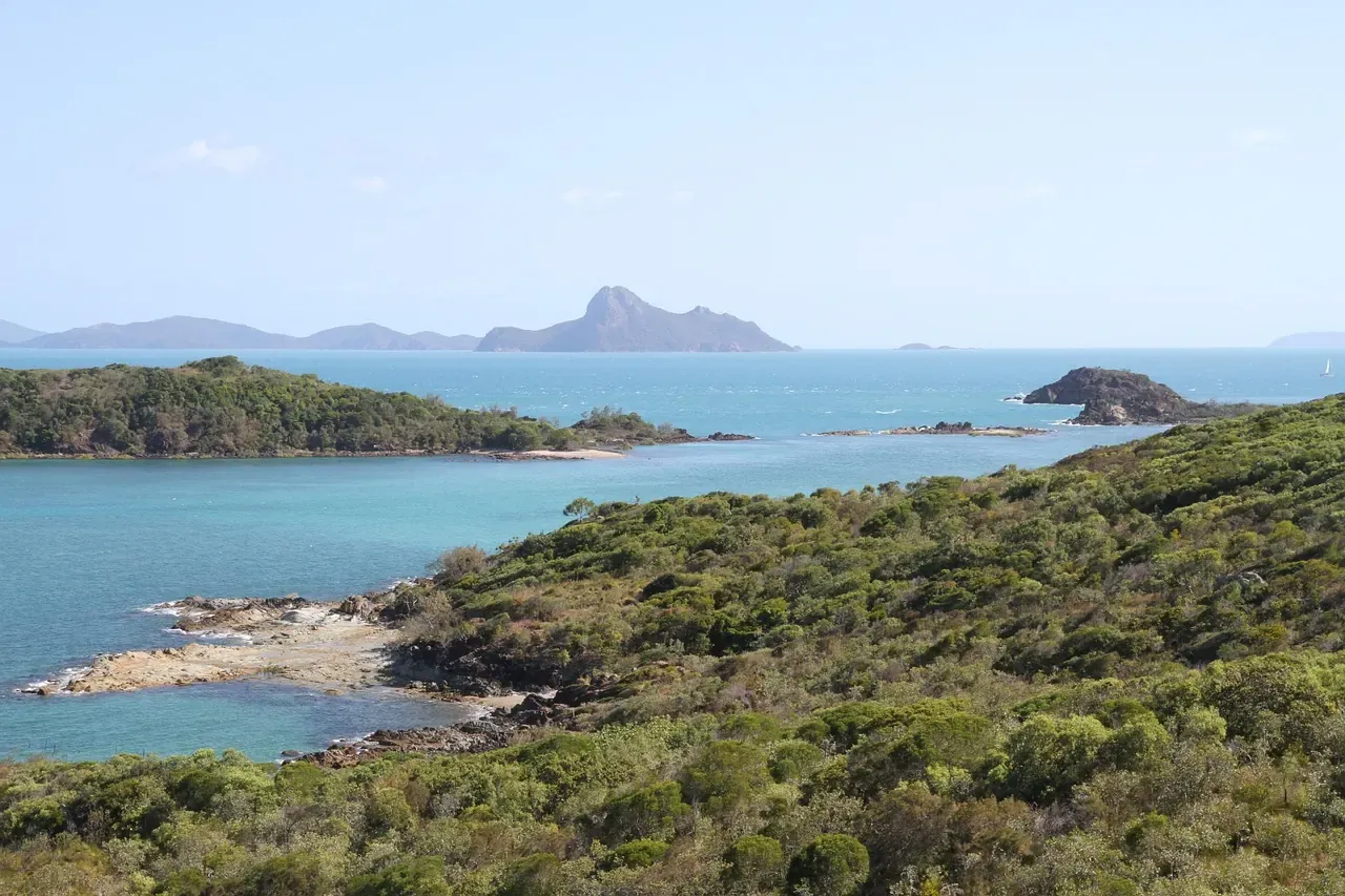 Wooded Whitsunday Islands and their beaches seen from the water in Queensland