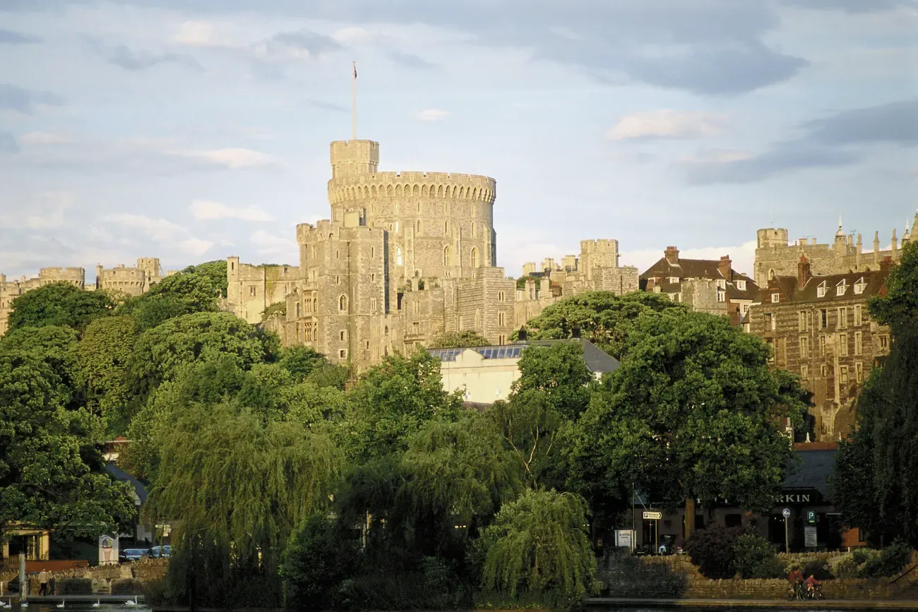 Windsor Castle's Round Tower rising above the trees, seen from the riverside