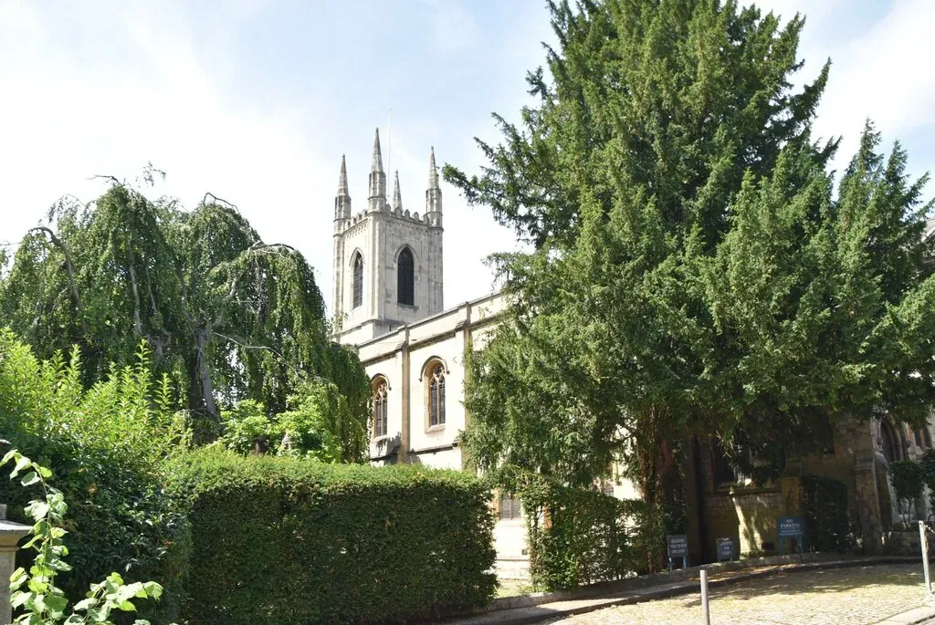 The tower and nave of St John the Baptist, the parish church of Windsor, seen through the churchyard trees