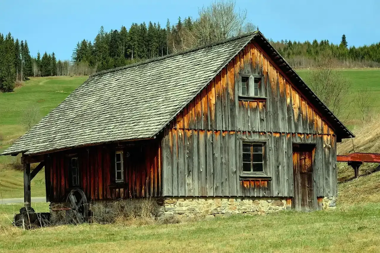 A wooden farm mill with a shingled roof in the Black Forest