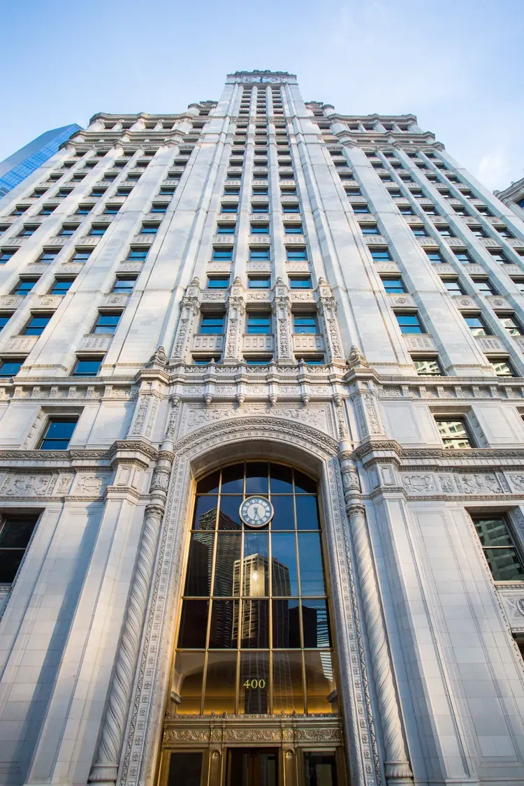 Looking up the white terracotta facade of the Wrigley Building in Chicago