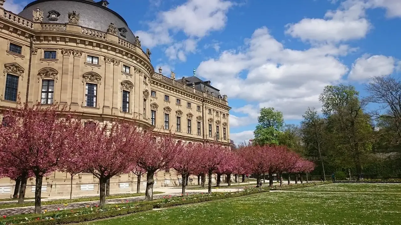 The Würzburg Residence behind trees in spring blossom
