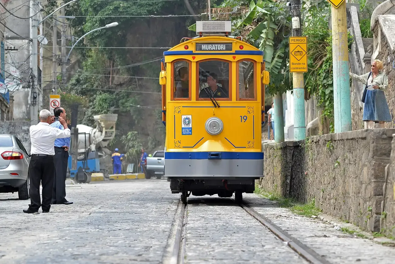 The yellow bonde tram climbing a cobbled street in Santa Teresa, Rio de Janeiro