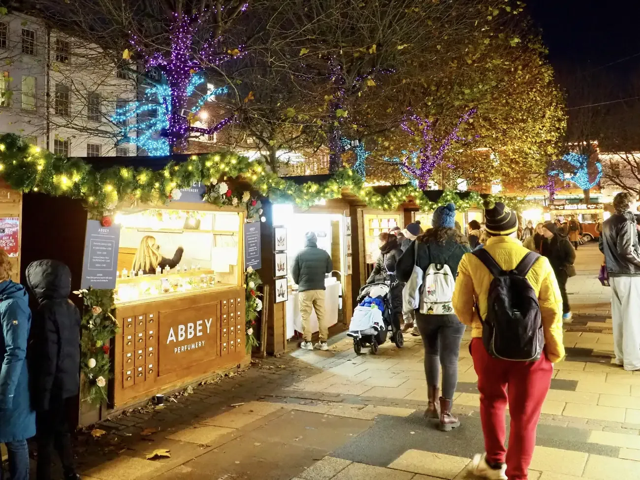 Stalls of York Christmas Market on Parliament Street at dusk