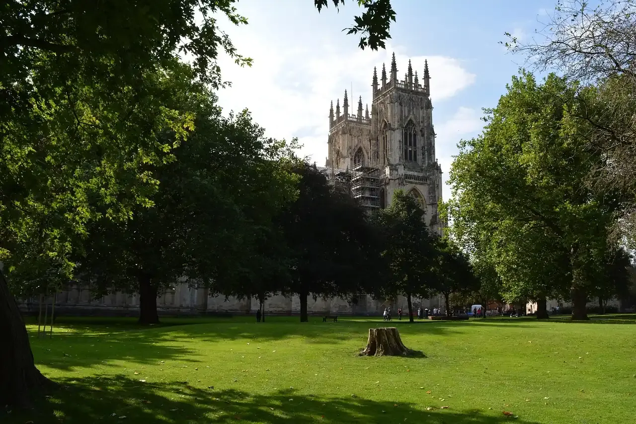 York Minster seen across the trees and lawns of a park in York