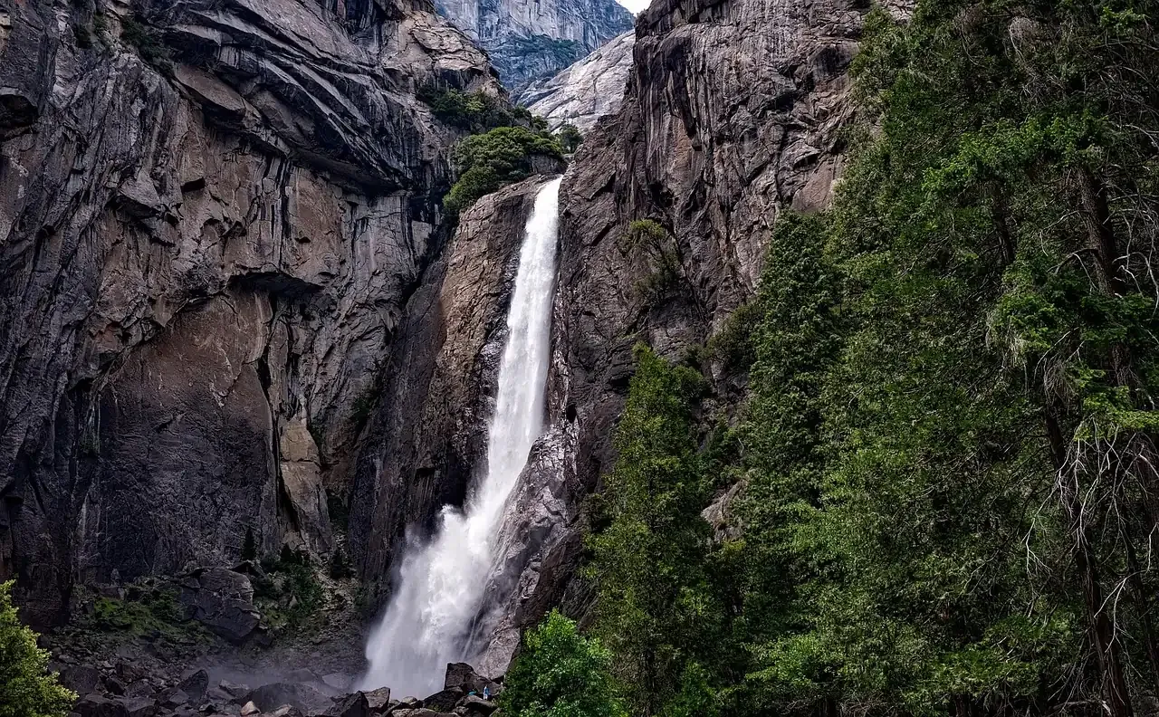 A waterfall dropping through granite and pines in Yosemite, California