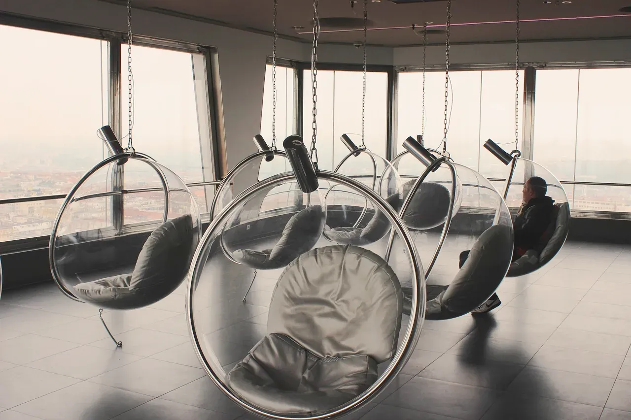 Hanging chairs facing the windows on the observation deck of the Zizkov Television Tower